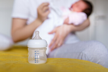 Obraz na płótnie Canvas Bottle feeding concept artificial formula food milk for babies copy space