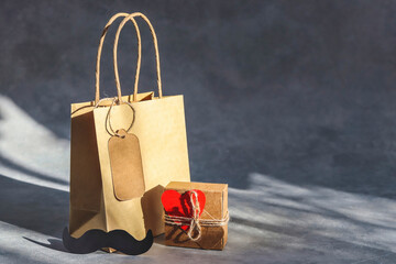 Shopping bag and gift box on a dark gray background.