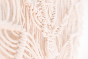 wall panel in boho style made of cotton threads of natural color