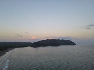 Moon Rising over a Peninsula with the ocean in the foreground