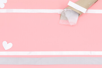 Brown paper funnel have empty white paper for text and white heart paper 
White Ribbon frame on pink background with valentines. Valentines day concept festive food gifts