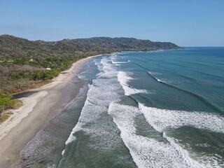Lush Tropical Beach Paradise with blue water, great waves and rock formations in Malpais / Santa Teresa, Nicoya Peninsula Costa Rica