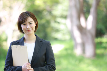 Fototapeta premium バインダーを持つ女性社員