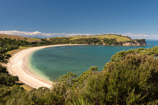 Elevated view of the sandy beach at Te Haruhi Bay at Shakespear Regional Park, Whangaparaoa, Auckland, New Zealand, on a sunny day.