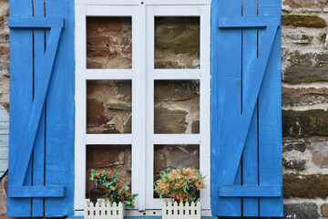 blue and white glass frames of an old stone house