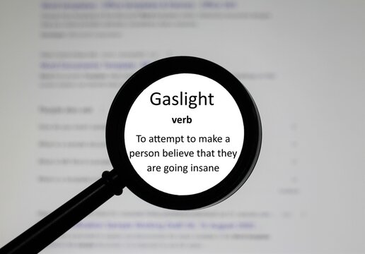 Selective focus on word Gaslight, word in a dictionary. Close up of an English dictionary page with the word Gaslight