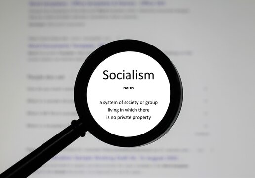 Selective focus on word Socialism, word in a dictionary. Close up of an English dictionary page with the word socialism 