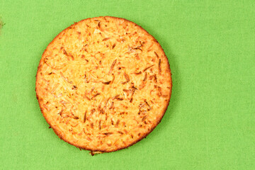 Whole cassava cake on green fabric background