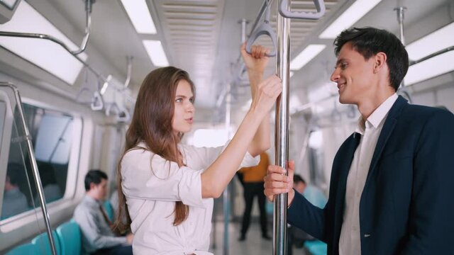 Businesswoman standing on the skytrain or subway talking and discusstion businessman on their way to working transportation people diversity lifestyle concept.