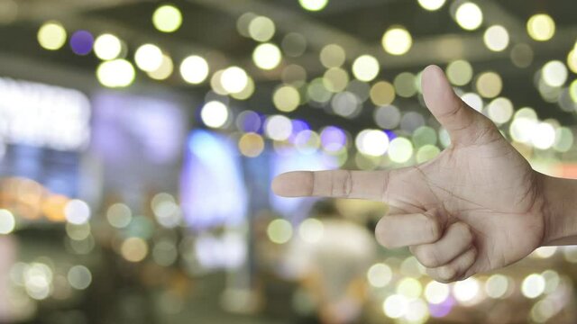 cctv camera flat icon on finger over blur light and shadow of shopping mall, Business security and safety concept