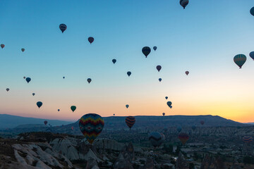 Daily take-off of balloons in Cappadocia, on the city of Goreme, Turkey.