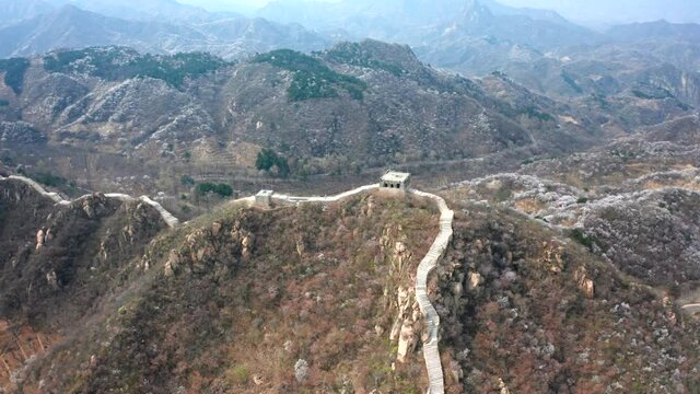 Aerial photograph of the winding ancient Great Wall in spring mountain area of Beijing