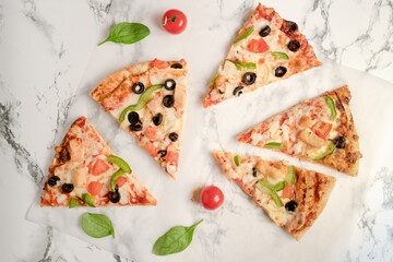 A several pieces of tasty pizza on a grey marble tabletop top view