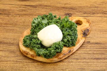 Soft mozzarella cheese over board
