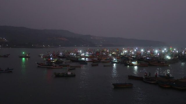 Timelapse of traditional fishing boats at Harbour during sunset in near Ratnagiri, Maharashtra