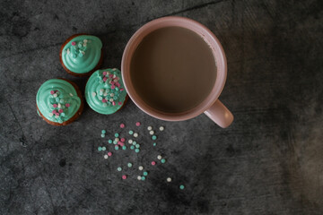 Obraz na płótnie Canvas cupcakes in green glaze. powdered sugar. cocoa or coffee