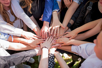 Group of children putting their hands together. Concept teamwork partnership