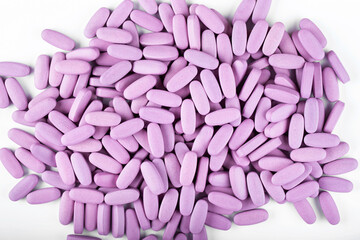 Purple pills on a white background. Global health care concept. Antibiotics drug resistance.