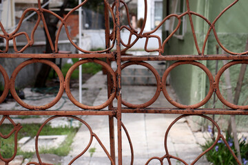 Fototapeta na wymiar old rusty metal fence of a house