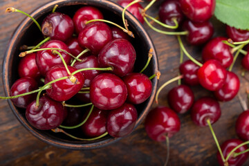 Freshly harvested cherries in a clay bowl from your home garden.