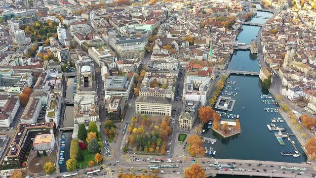 Aerial drone view of Zurich city with the old town around the Limmat river that lies next to the business and financial district and the Parade Platz in Switzerland. Shot with a forward motion