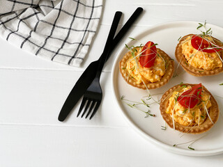 tartlets and stuffing with tomato and microgreen