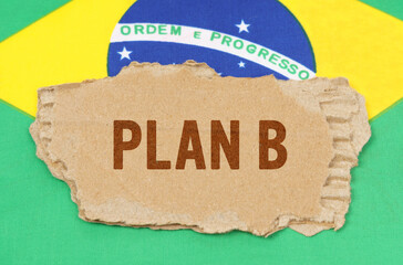 Against the background of the flag of Brazil lies cardboard with the inscription - PLAN B