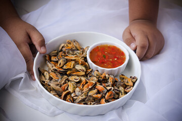 Poached mussels with seafood sauce in white plate