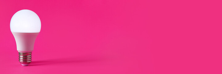 Glowing light bulb on magenta background. Discovery, invention, new idea concept. Web banner with...