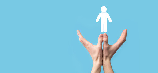 Fototapeta premium Male hand holding human icon on blue background. Human Resources HR management Recruitment Employment Headhunting Concept.Select team leader concept. Male hand click on man icon.Banner ,copy spase.