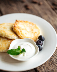 Russian breakfast cottage cheese pancakes with sour cream