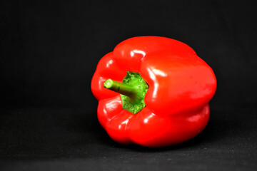 Close-up red bell pepper on black background,food photo