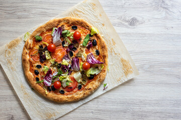 round pizza top view on kraft sheet on light background