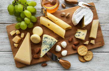 Fototapeta na wymiar Various types of cheese on a white wooden background