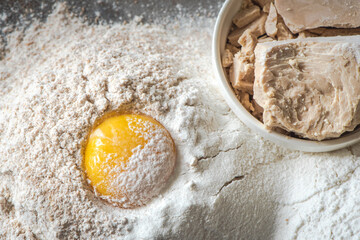 Preparation of the dough . The egg with the flour and dry yeast. Pizza dough. Top view
