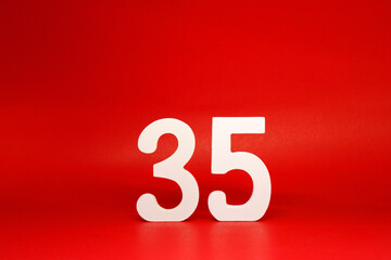 Thirty Five ( 35 ) white number wooden Isolated Red Background with Copy Space - New promotion 35% Percentage  Business finance Concept 