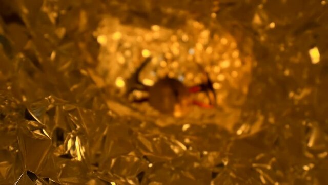 Metallic, golden color, Bitcoin coin and two pickaxes imply the mining of cryptocurrency. The camera moves slowly through the cave where digital gold is being mined. Macro. Closeup