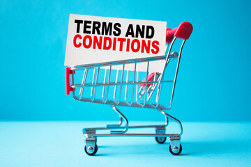 a business card with text TERMS AND CONDITIONS in a shopping cart. business and finance