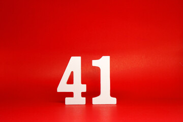 Forty One ( 41 ) white number wooden Isolated Red Background with Copy Space - New promotion 41% Percentage  Business finance Concept 