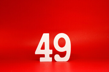 Forty Nine ( 49 ) white number wooden Isolated Red Background with Copy Space - New promotion 49% Percentage  Business finance Concept 