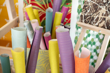 Bright colored paper and Wallpaper, standing in rolls. Interior design