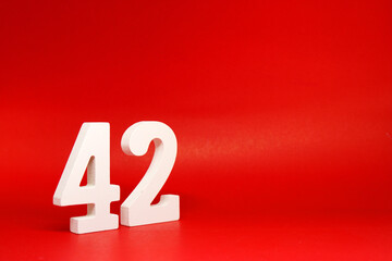 Fourty Two ( 42 ) white number wooden Isolated Red Background with Copy Space - New promotion 42% Percentage  Business finance Concept 