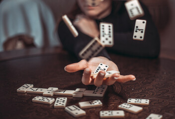 Cropped image of woman playing dominoes at table. Young adults playing the game of Domino with...