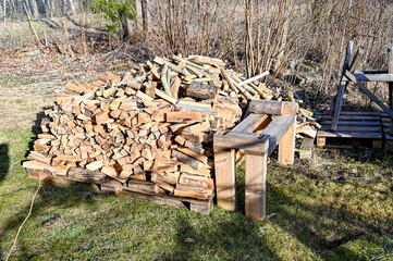firewood piled in a Swedish garden drying for winter