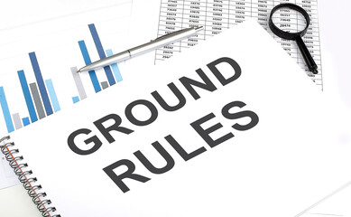 In the notebook, the text GROUND RULES , next to magnifier and pen, the background is graphics.