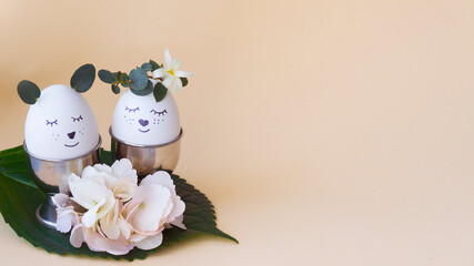 Easter composition. Two eggs are decorated with flowers and cute emoticons