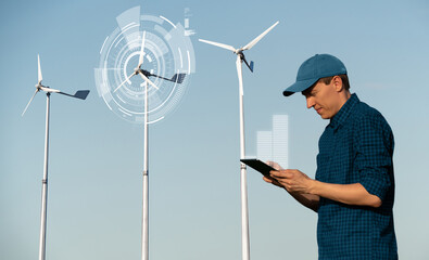 Engeneer with tablet computer on a background of wind turbines