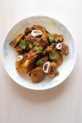 Mutton ghee roast. Goat meat fry with potatoes, also known as Mutton Batata bhujing. Spicy non-vegetarian lamb fry dish. Mutton curry or mutton fry. copy space.