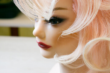 Mannequin Woman head  with hairstyle  on dark background.