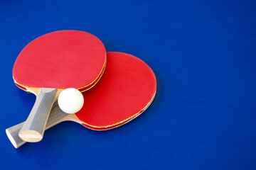 Two racket  for Table tennis  on blue background with copy space .